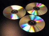 Three shiny compact disks